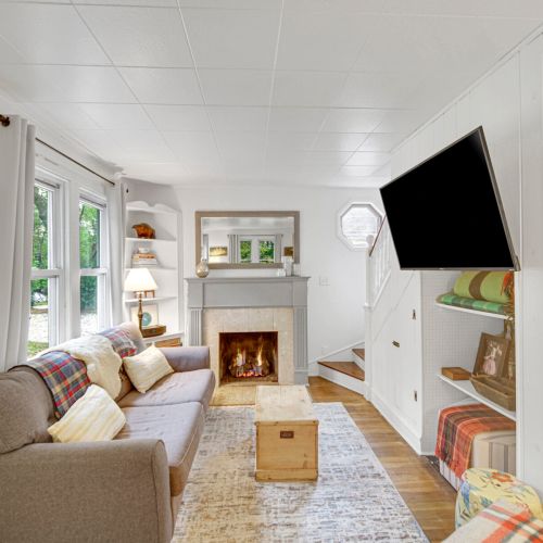 Living room with fire place and smart tv.