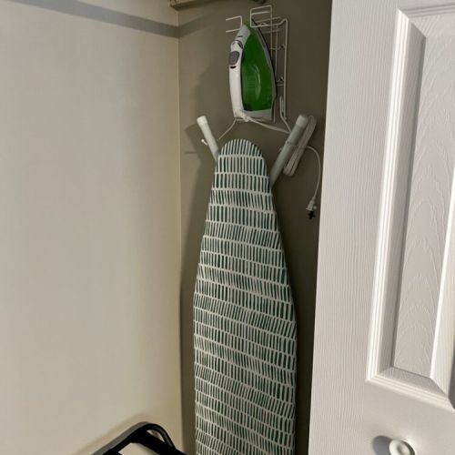 Ironing board and iron in the main bedroom closet.