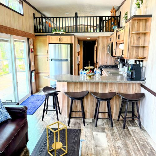 Kitchen with a sliding glass door, connecting the interior space to the tranquil lake setting just outside.