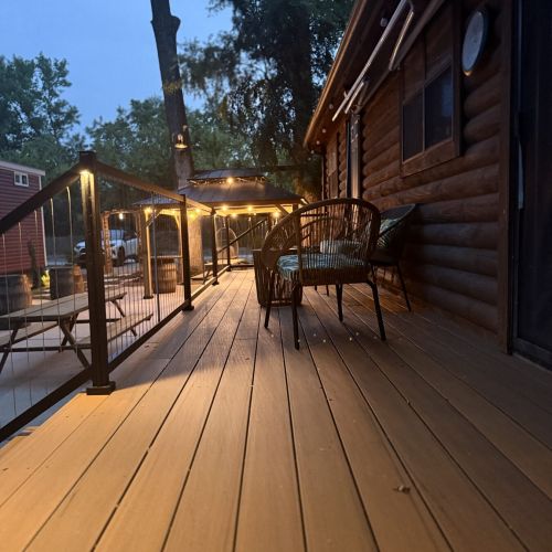 Another angle of the deck at night, with warm lights creating a welcoming atmosphere.