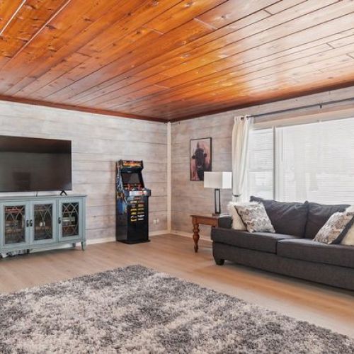 Additional view of the living room, showcasing the seating area and entertainment amenities.