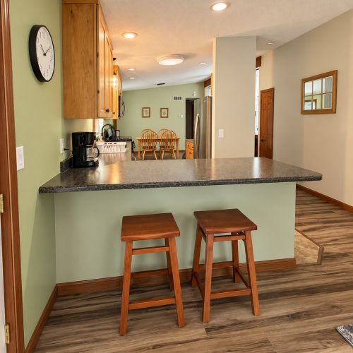 Kitchen bar seating area with comfortable stools, perfect for casual dining or enjoying a morning coffee.