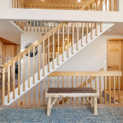Living Room with stairs to the loft and access to the main floor bathroom