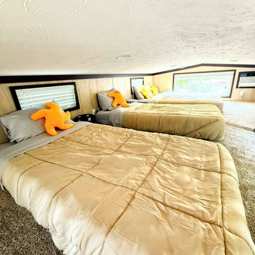 Loft area with three beds, perfect for additional guests.