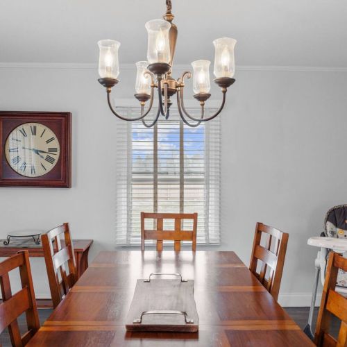 Dining room that seats 6 guests with a high chair