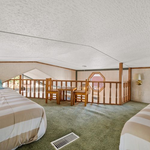 Small two-top table with chairs in the loft, ideal for games or a quiet space to unwind.