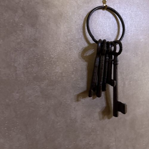 Close-up of antique-style keys, adding to the whimsical and magical theme of the Funky Wizard travel trailer.