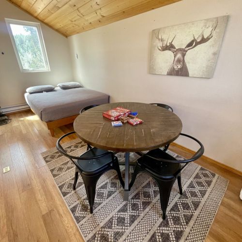 Loft with Queen bed, a portable closet & a table for 4