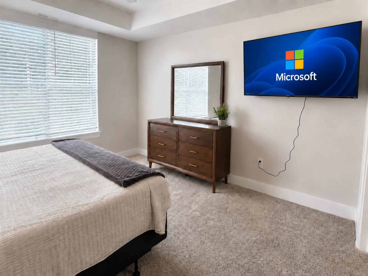 Bedroom with dresser, mirror and TV