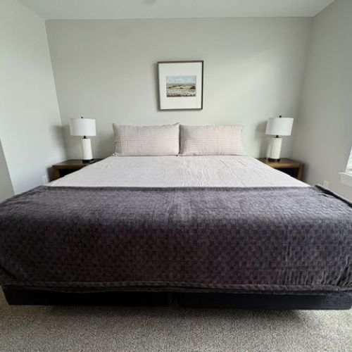 Bedroom has King Bed and two side tables with lamps