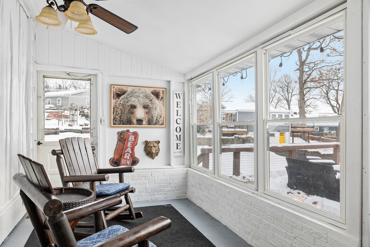 Relax in the sunny three-season room, perfect for enjoying the outdoors in comfort during spring, summer, and fall.