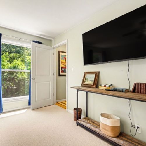 Bedroom 1- Another view with entrance to private bathroom and smart tv.