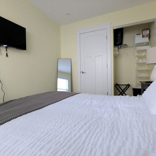 Guest Bedroom 1 with full-length mirror and extra closet space to unpack your belongings.