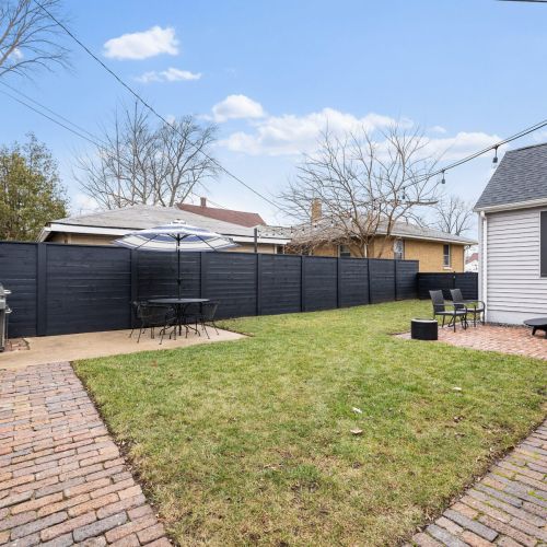 Fenced in Private Backyard with Grill, Fire Pit, and Seating