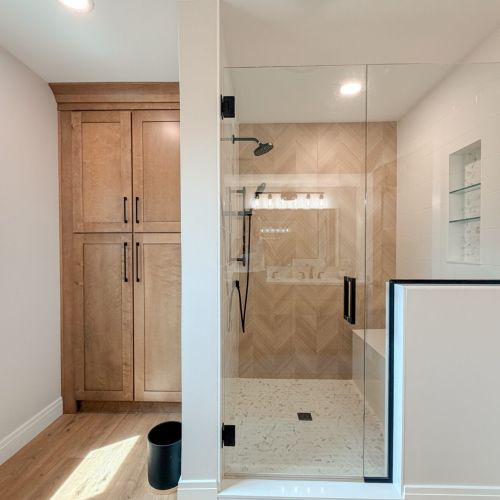 Walk-in shower featuring a clean, modern design.