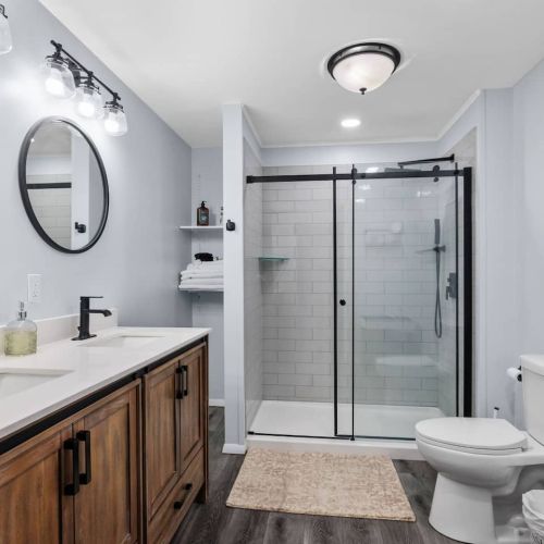 3/4 bathroom with shower and double vanity sink