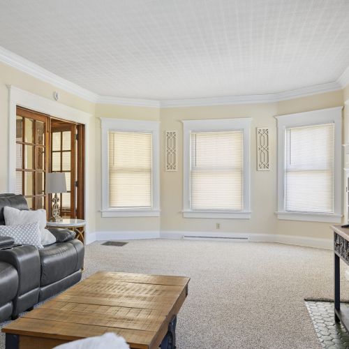 Windows in the living room with doorway to the front entrance.