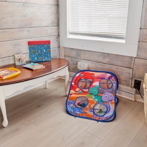 A kid-friendly area featuring a playful toss game and books to keep little ones entertained.