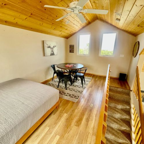 Loft with Queen bed, a portable closet & a table for 4