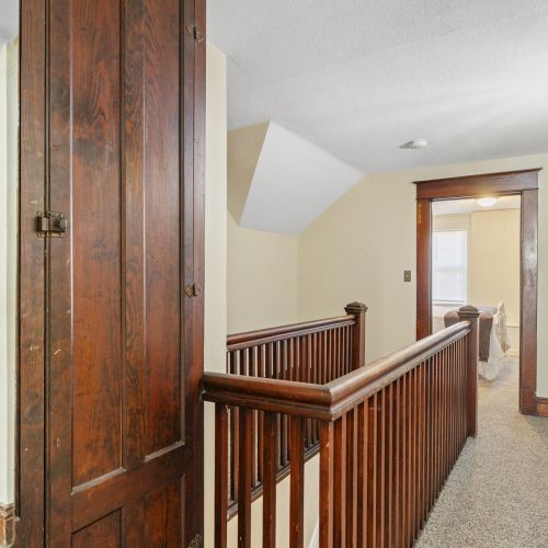 Stairwell overlooking a bedroom, creating an open and airy feel.