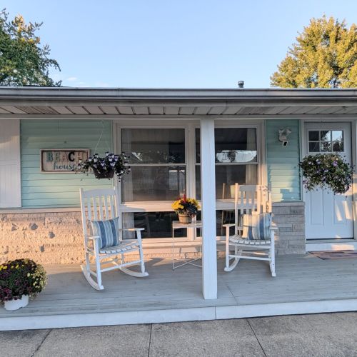 Charming front porch with cozy rocking chairs — the perfect spot to unwind.