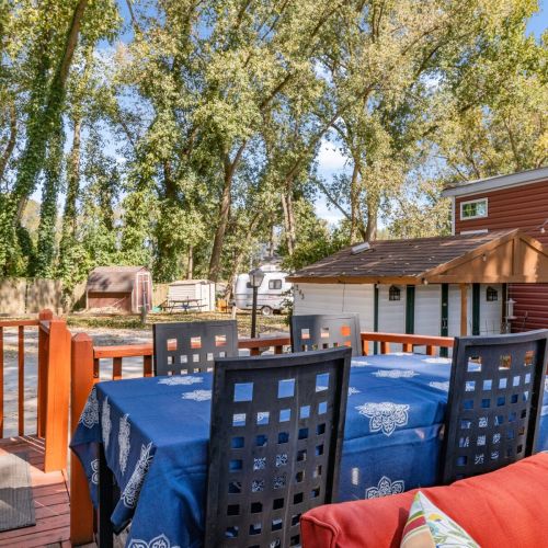 Four-top dining table outside, ideal for meals or drinks while taking in the scenic surroundings.