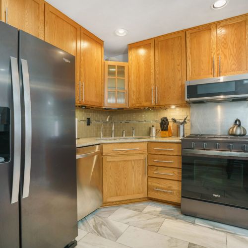 Stainless appliances for you to use and cabinets and drawers with supplies for your convenience.