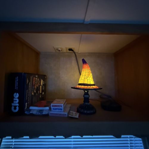 Whimsical wizard’s hat with family-friendly games nearby, perfect for fun and entertainment during your stay.