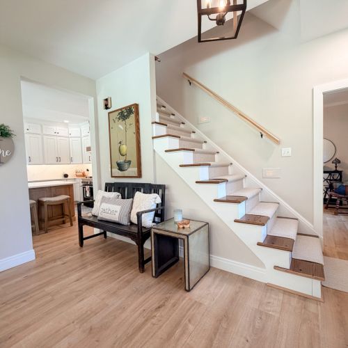 Additional view of the entryway with stairs leading to the upper level.