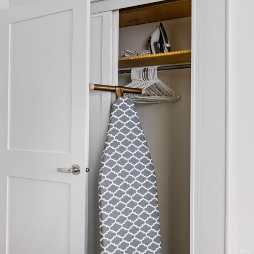 There is an ironing board and iron located in the closet of Bedroom #1