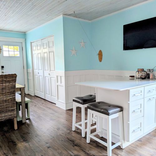 Charming breakfast nook with dining table and convenient side entrance.