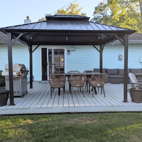 Spacious back porch with grill and outdoor dining — perfect for gathering