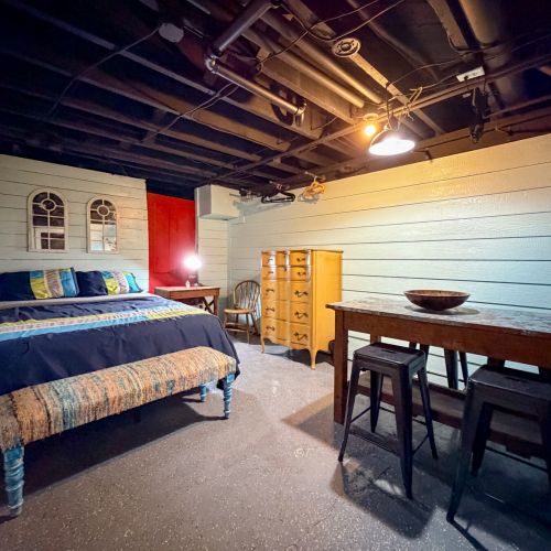 Lower Unit - Bedroom featuring a cozy queen-size bed.