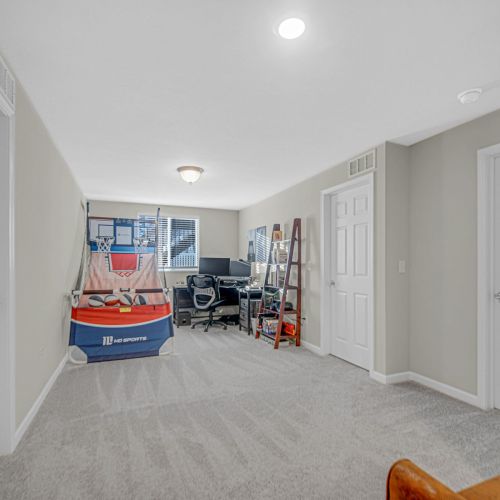 Multi-purpose office area featuring a desk, computer, and games.