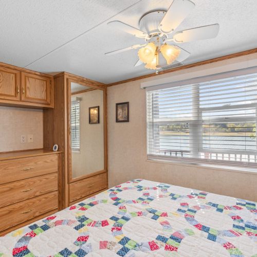 Relax in the cozy main bedroom while enjoying serene views of the lake right from your window.