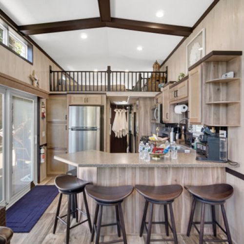 Kitchen with a sliding glass door, connecting the interior space to the tranquil lake setting just outside.