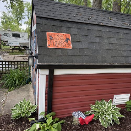 Side view of the shed, showing its design and placement on the property.