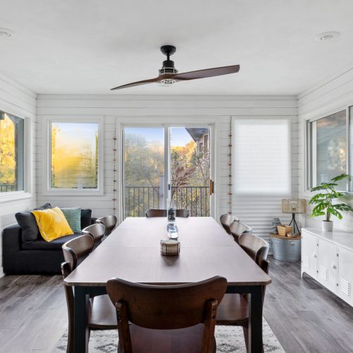 Willow on the Pond - Four season dining area with a view of the back deck — perfect for enjoying meals with natural light and outdoor scenery.