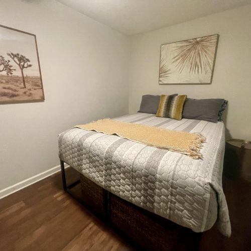 This is bedroom two - with a queen size bed and two side tables.