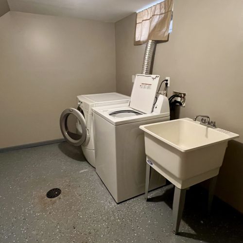 Laundry area that is located in the basement.