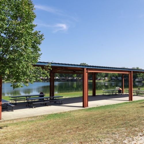 Shaded pavilion overlooking the lake, perfect spot for a picnic.