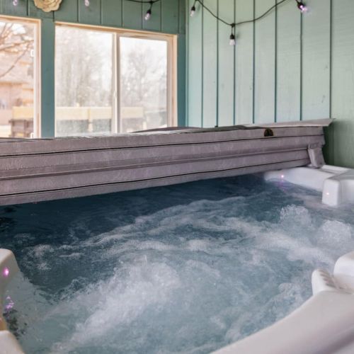 Hot tub for 5 people sits in enclosed porch