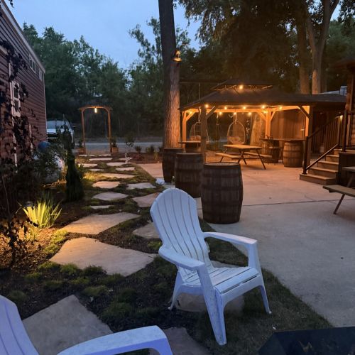 Another angle of the deck at night, with warm lights creating a welcoming atmosphere.