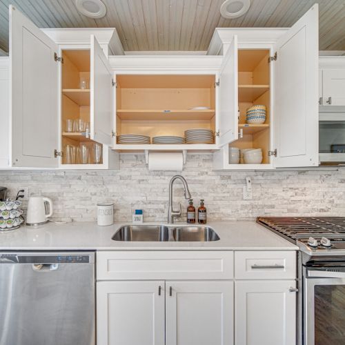 Kitchen stocked with dishware and glasses.