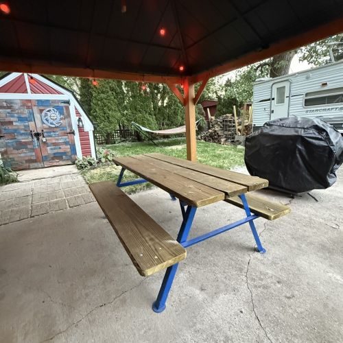 Pavilion and picnic table view of the trailer and shed side, offering a convenient outdoor gathering space.