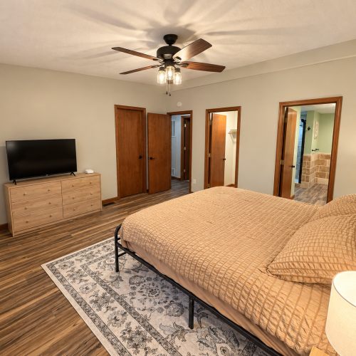 Spacious master bedroom featuring a comfortable king-size bed and a relaxing atmosphere.
