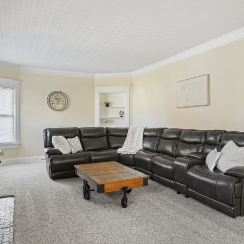 Cozy space to unwind, featuring a leather sofa and a Smart TV for entertainment.
