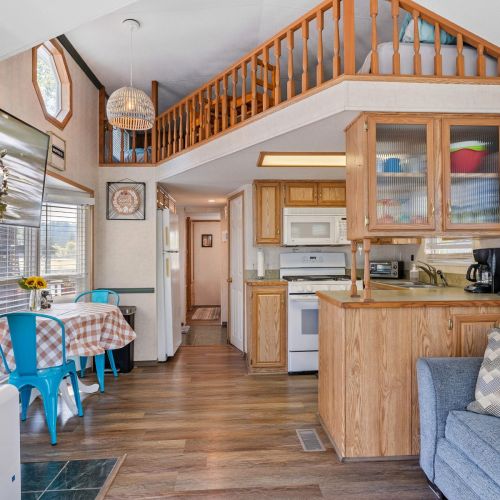 Functional kitchen featuring a small breakfast table for two, ideal for quick meals or morning coffee.