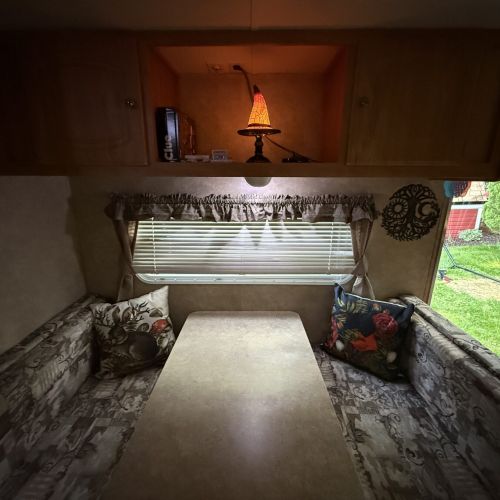 Dining table bathed in warm evening light, with a whimsical wizard’s hat adding a fun, magical touch.