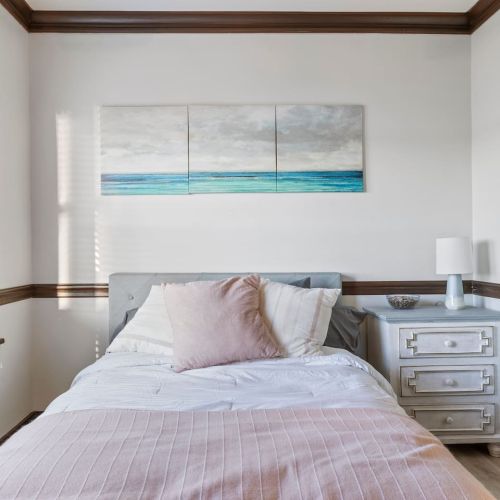 Bedroom with lake views and attached bathroom